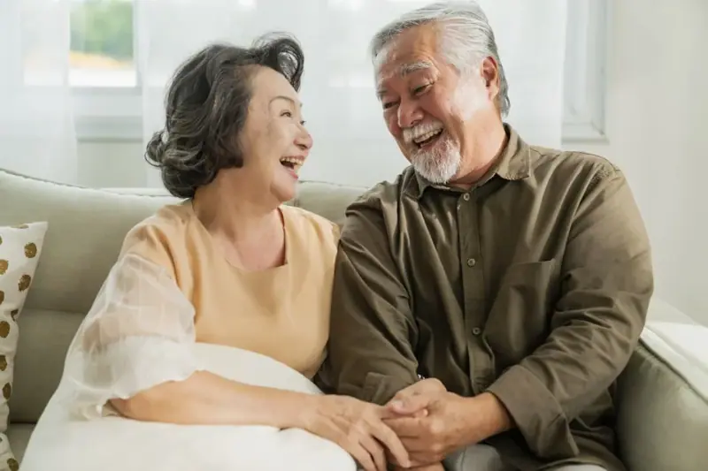 Smiling couple after completing their dental treatment